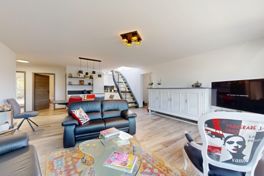 living room with stairs and wood finished floors