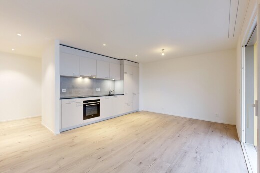 cuisine avec plans de travail, armoires blanches, sol en finition bois, wood finish floor, et cloison sèche