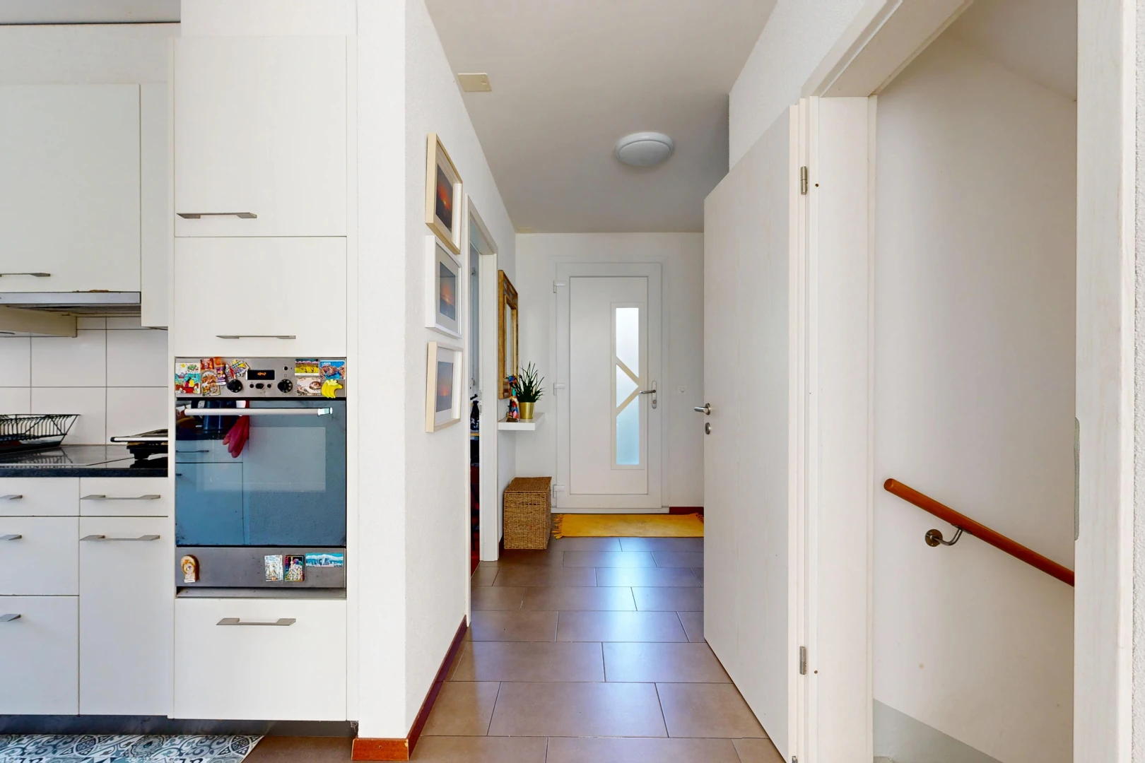 hallway with stairway and light tile patterned flooring