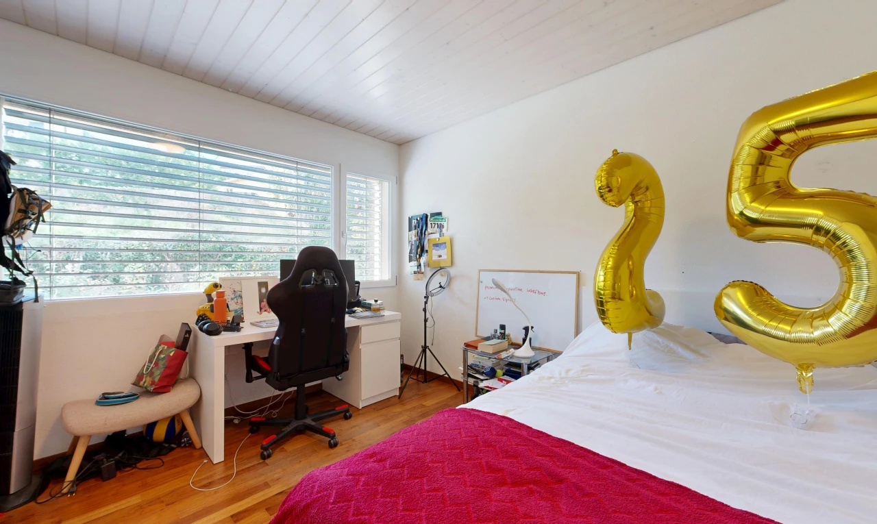 room / bedroom with light wood finished floors and a desk