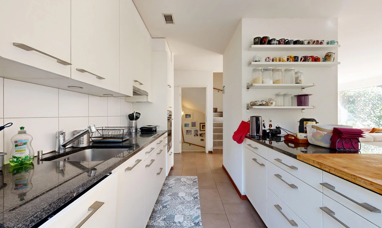 kitchen featuring white cabinets, open shelves, dark stone countertops, and light tile patterned flooring