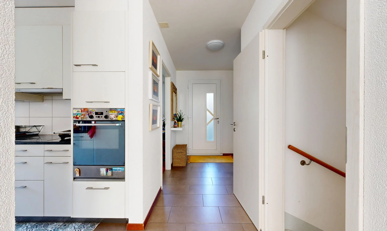 hallway with stairway and light tile patterned flooring