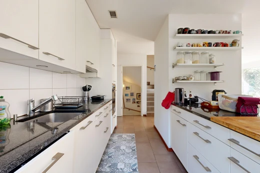 kitchen featuring white cabinets, open shelves, dark stone countertops, and light tile patterned flooring