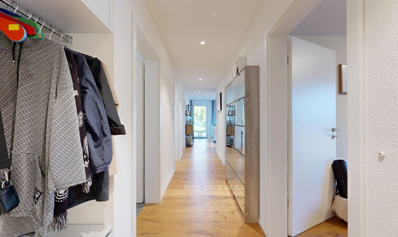couloir avec light floor, éclairage encastré, sol en finition bois, wood finish floor, et inside property