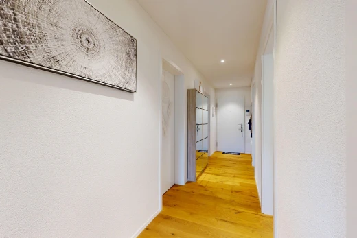 couloir avec light floor, éclairage encastré, wood finish floor, sol en finition bois, et inside property