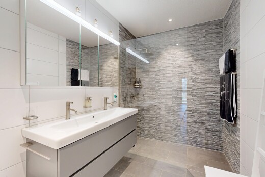 full bath with walk in shower, double vanity, tile walls, light tile patterned floors, and recessed lighting