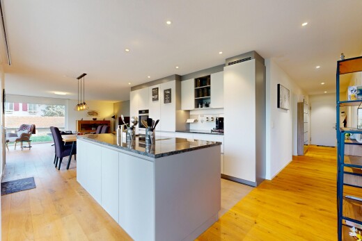 kitchen featuring recessed lighting, an island with sink, light wood-style floors, and white cabinetry