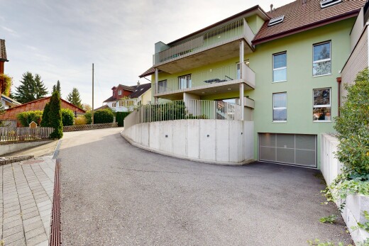 view of building exterior with a garage and driveway