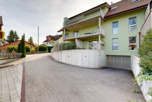 extérieur du bâtiment avec garage intégré, allée, et from community