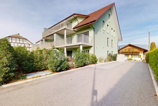 outdoor house with a balcony and stucco siding