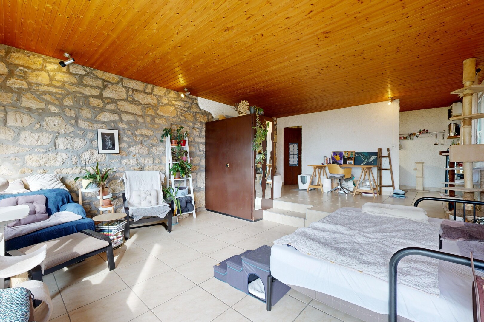 salon avec inside property, mur en pierre, stone wall, sol en carrelage, et tile floor