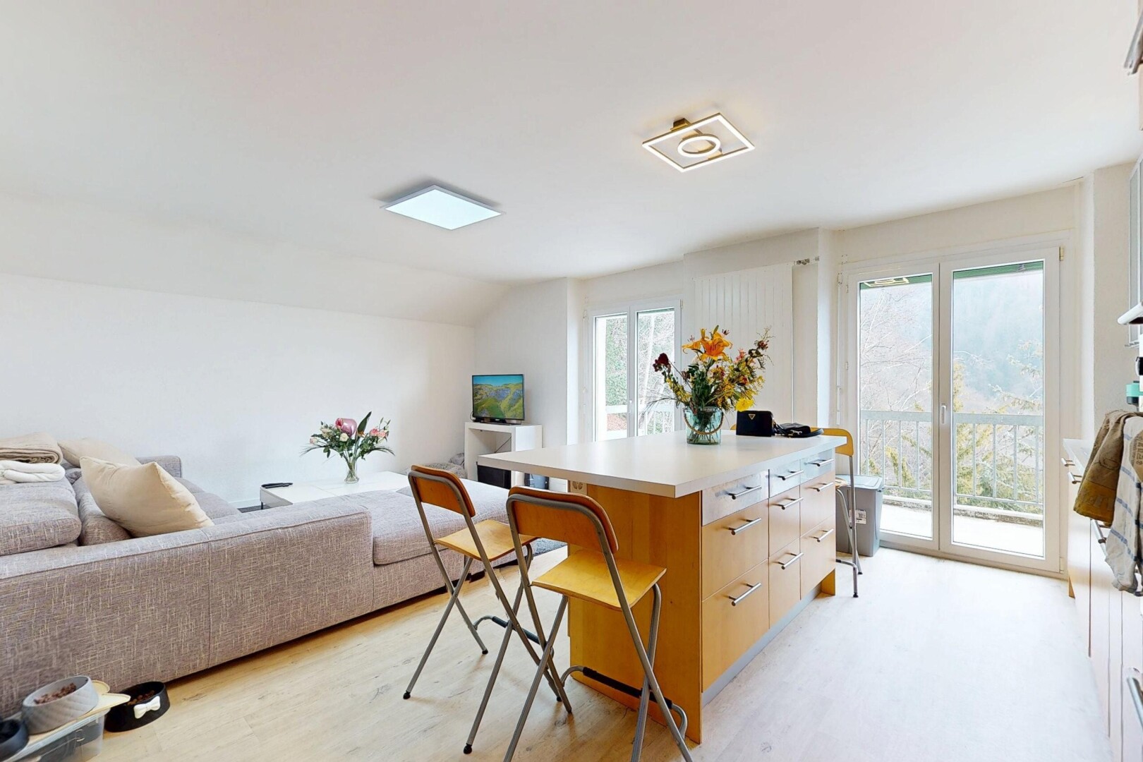 living / dining area with light wood-type flooring and lofted ceiling