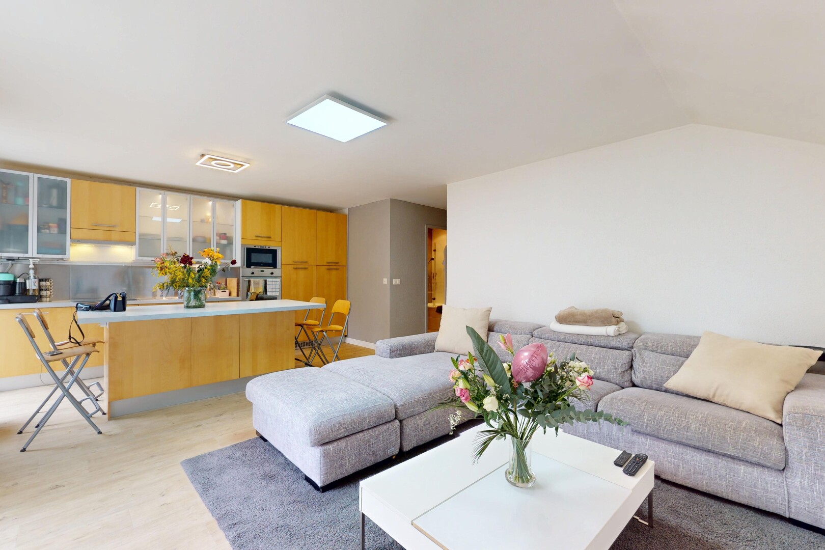 living area with light wood-type flooring and lofted ceiling