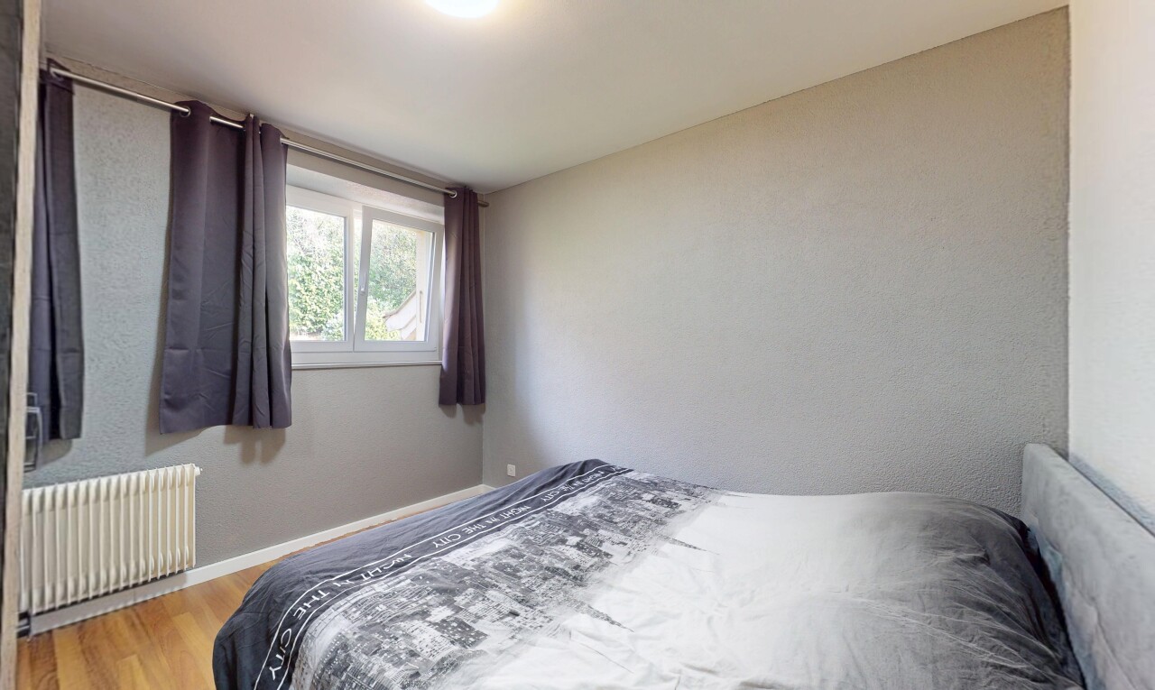 room / bedroom with radiator heating unit and wood finished floors