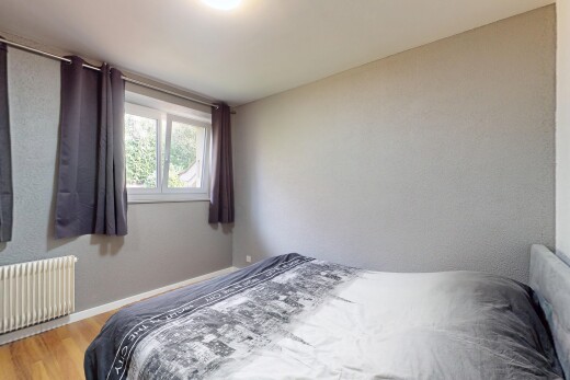 room / bedroom with radiator heating unit and wood finished floors