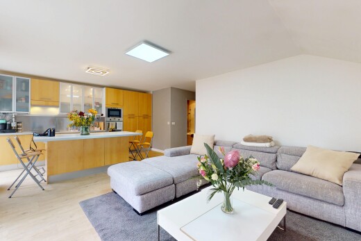 living area with light wood-type flooring and lofted ceiling