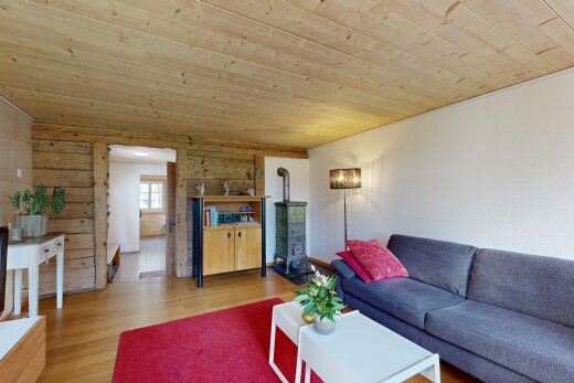 living area featuring light wood-style floors, wood ceiling, and wooden walls