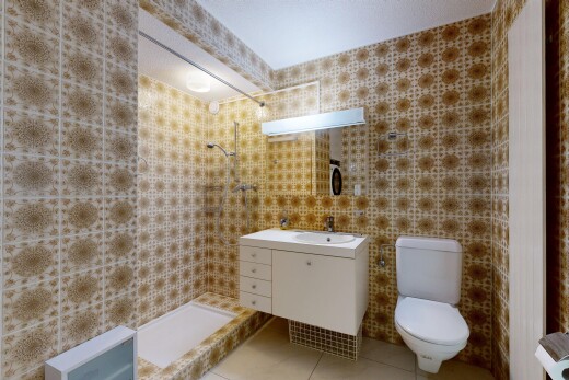 bathroom with tiled shower, vanity, light tile patterned floors, and tile walls
