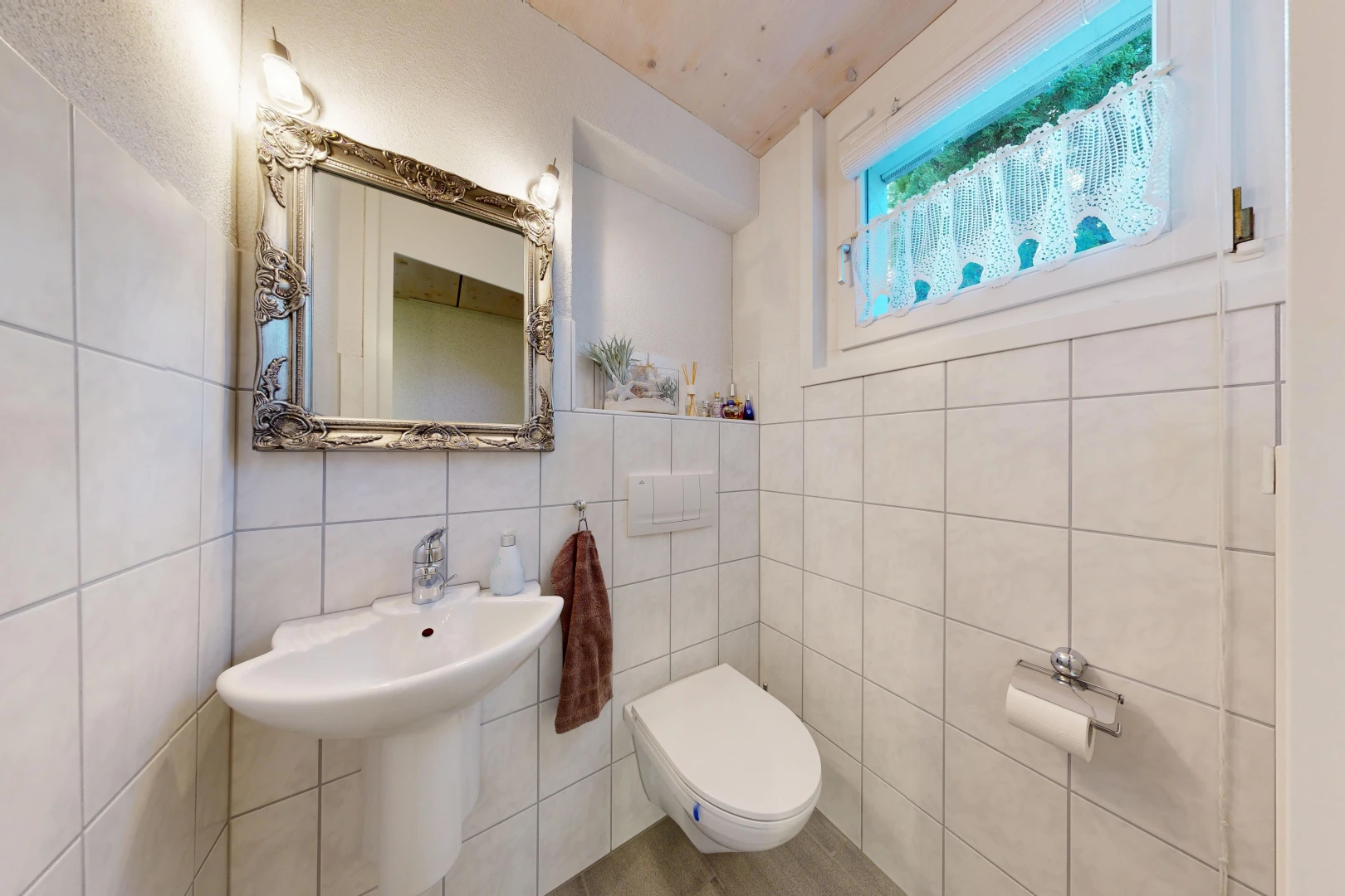 salle de bains avec miroir, tile wall, mur en carrelage, toilette, et inside property