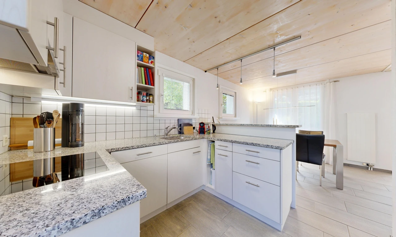 cuisine avec light countertops, plans de travail en pierre, stone countertops, armoires blanches, et white cabinets