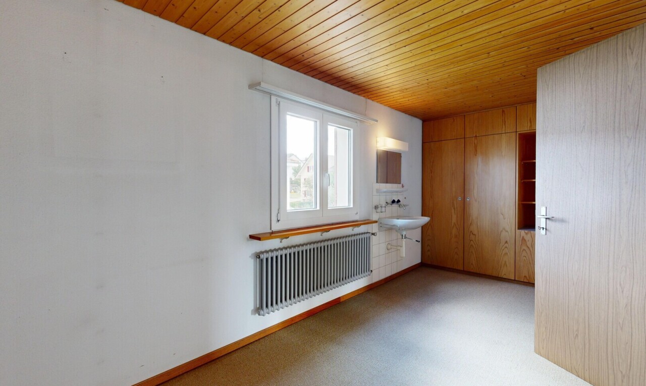 empty room featuring radiator heating unit, wooden ceiling, and carpet