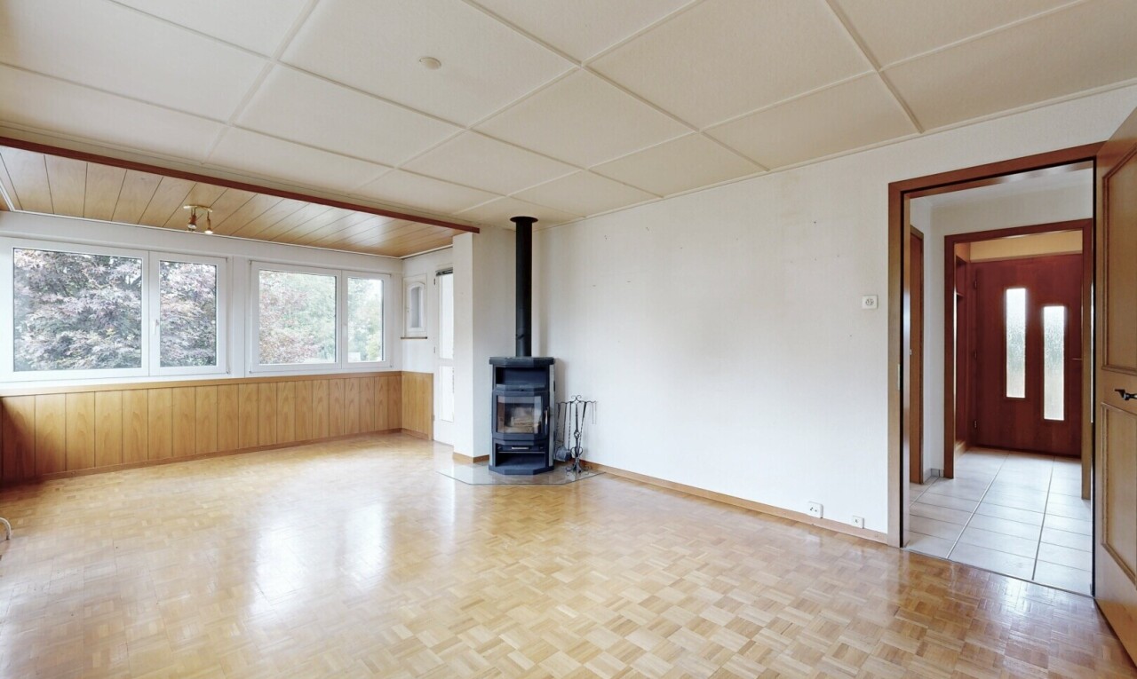 spare room featuring a wood stove and a paneled ceiling