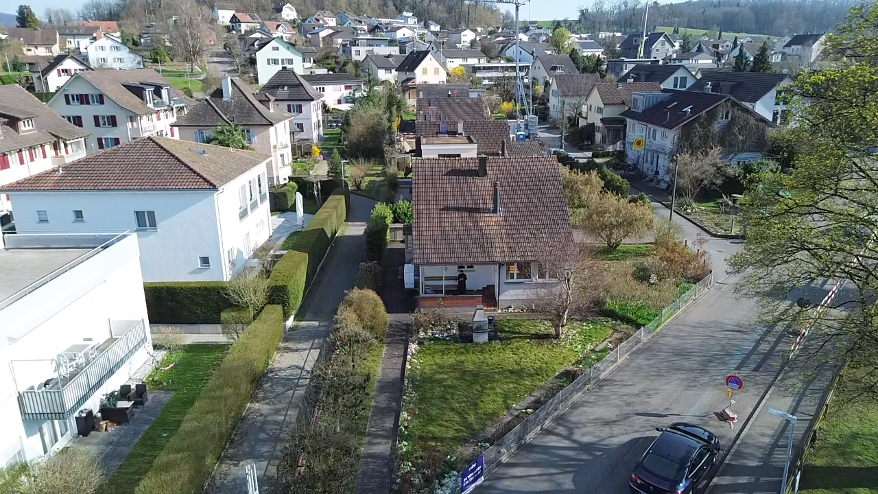 view of property featuring a residential view and a tile roof
