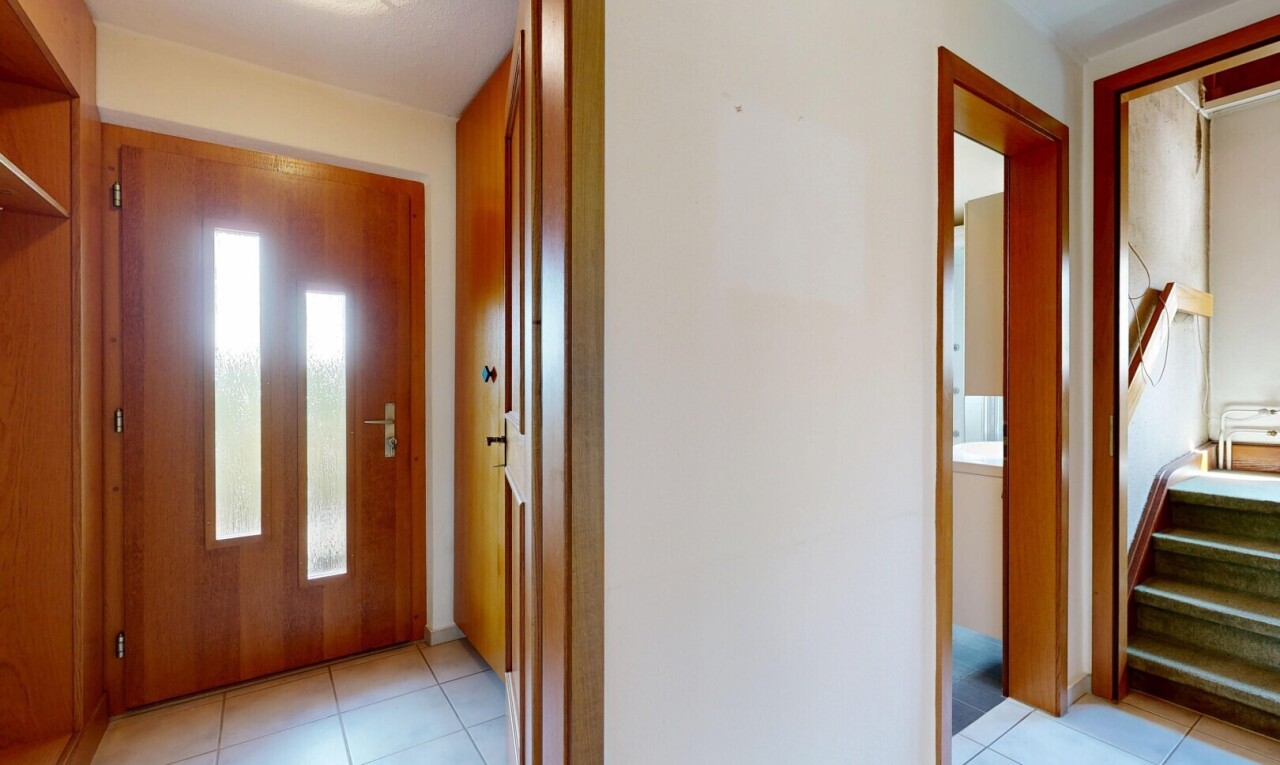 hall with light tile patterned floors