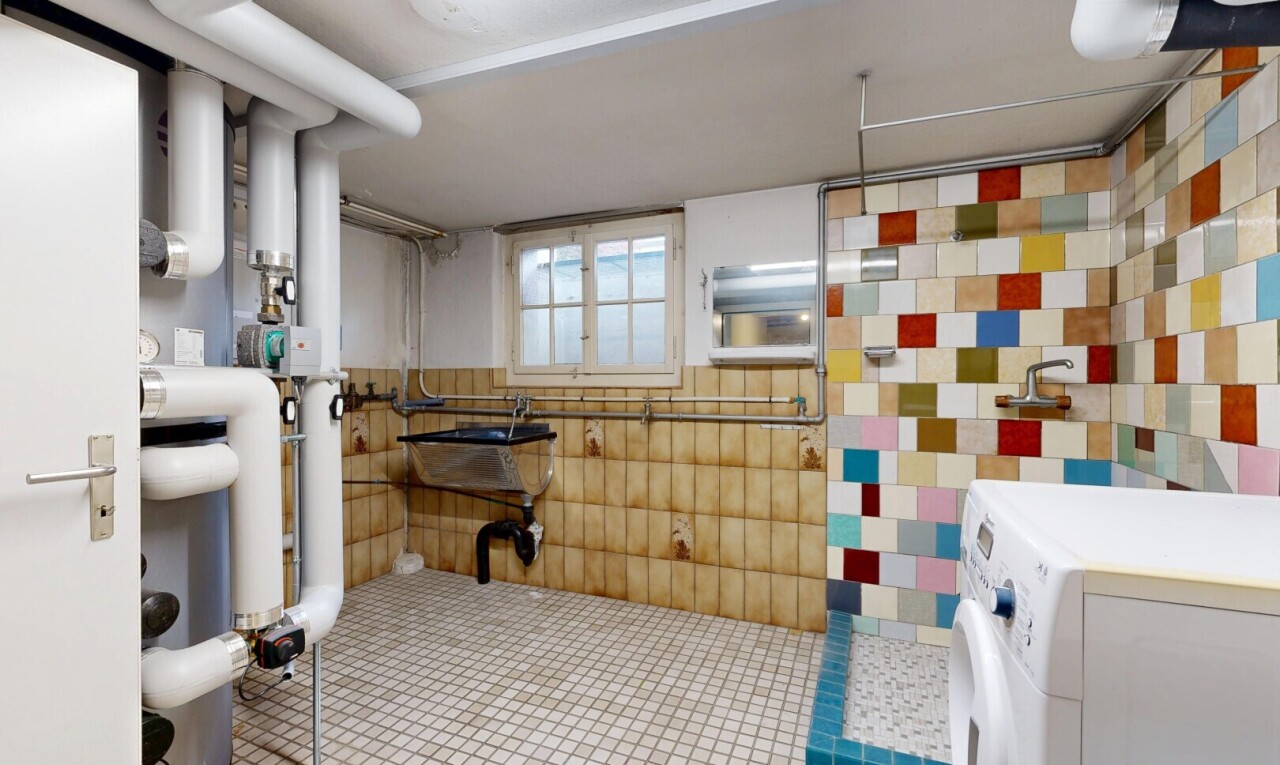 bathroom with washer / dryer and tile walls