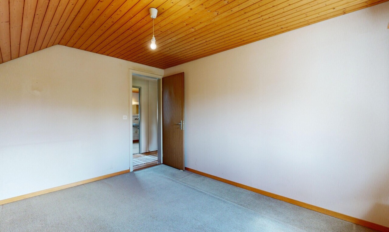 carpeted empty room with baseboards and wood ceiling