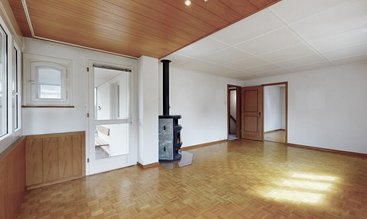 spare room with a wood stove and wooden ceiling