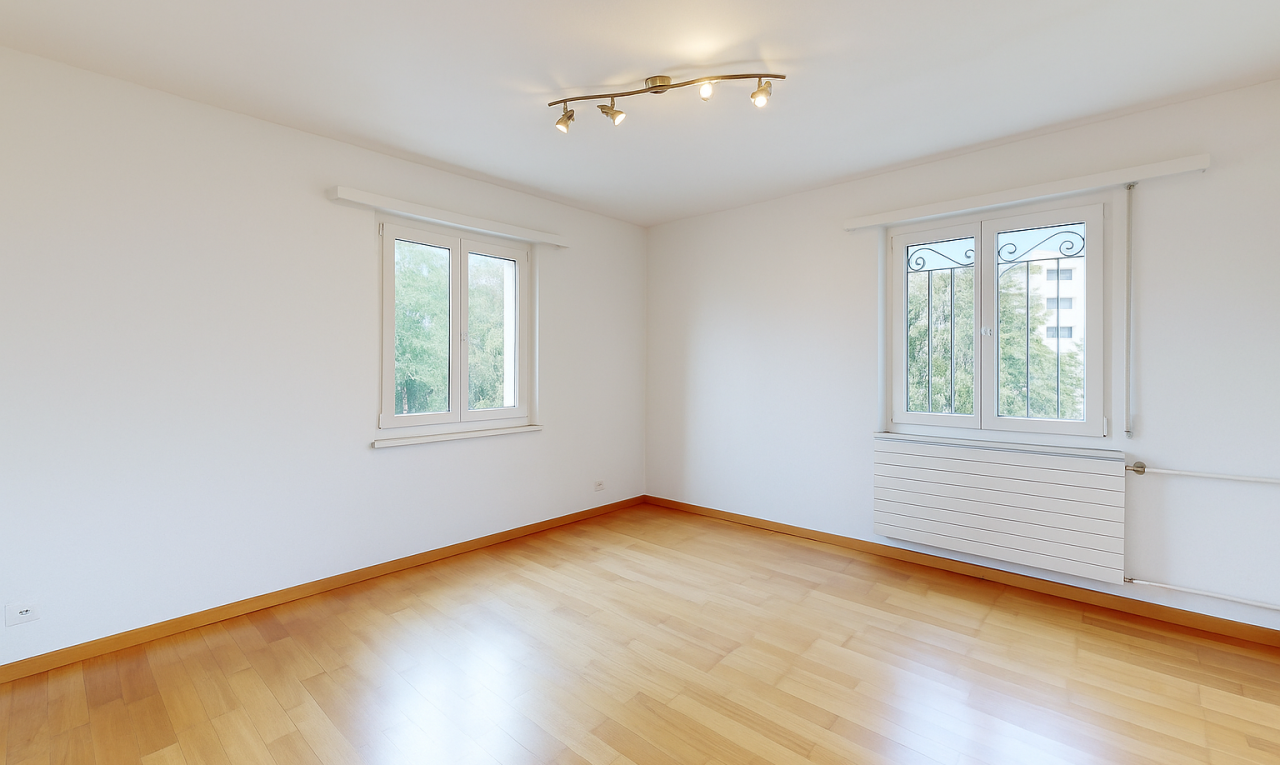 spare room with radiator heating unit and light wood finished floors