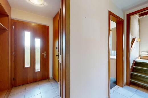 hall with light tile patterned floors