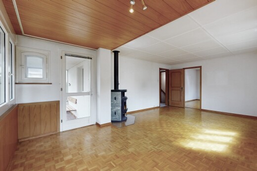 spare room with a wood stove and wooden ceiling