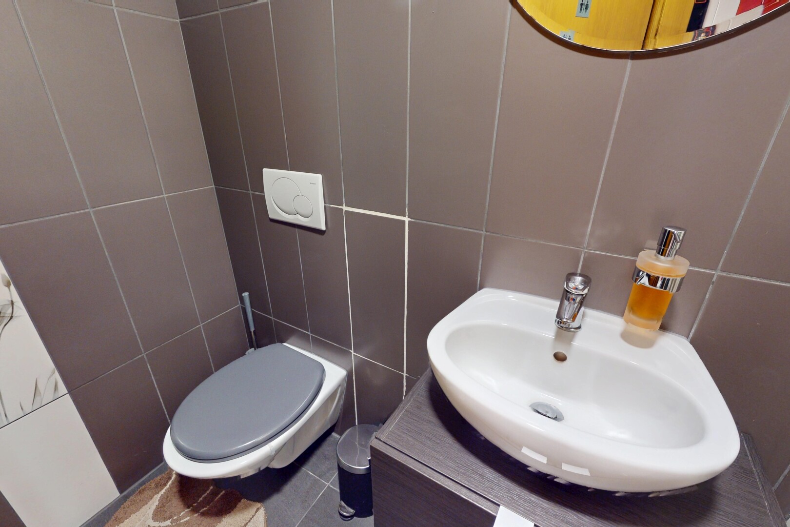 half bath featuring tile walls and vanity