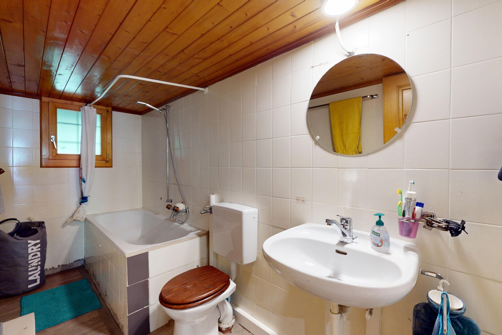 bathroom with tile walls, wooden ceiling, and shower / bath combination