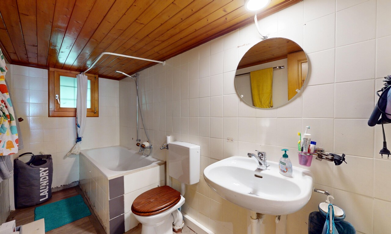 bathroom with tile walls, wooden ceiling, and shower / bath combination