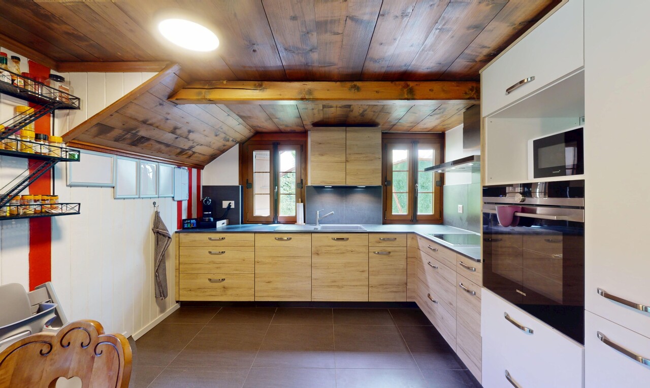 kitchen featuring black appliances, light brown cabinetry, wooden ceiling, tasteful backsplash, and dark tile patterned flooring