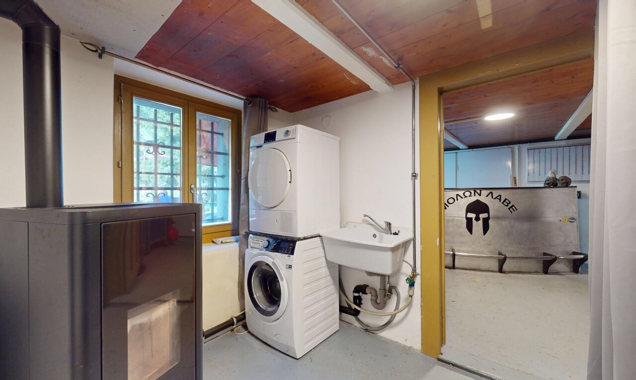 laundry area featuring stacked washing machine and dryer and wood ceiling