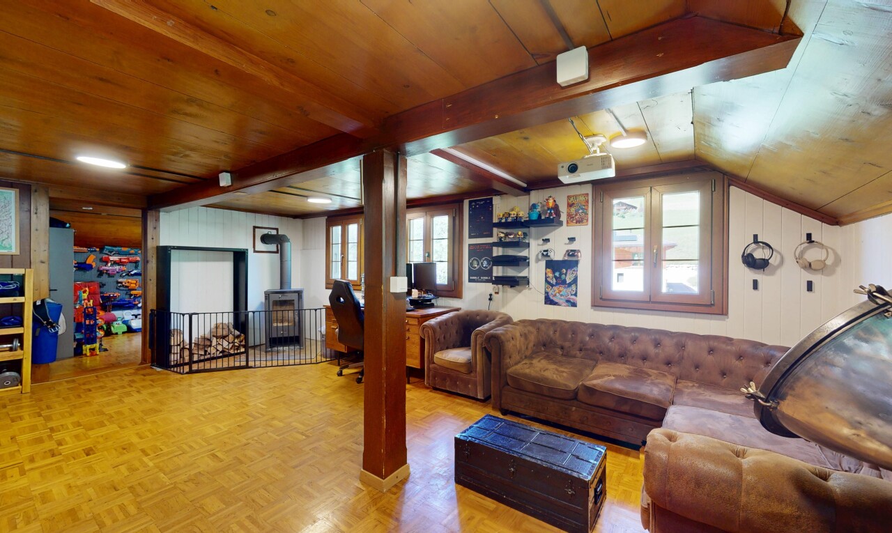 living room with a wood stove, vaulted ceiling, and wood ceiling