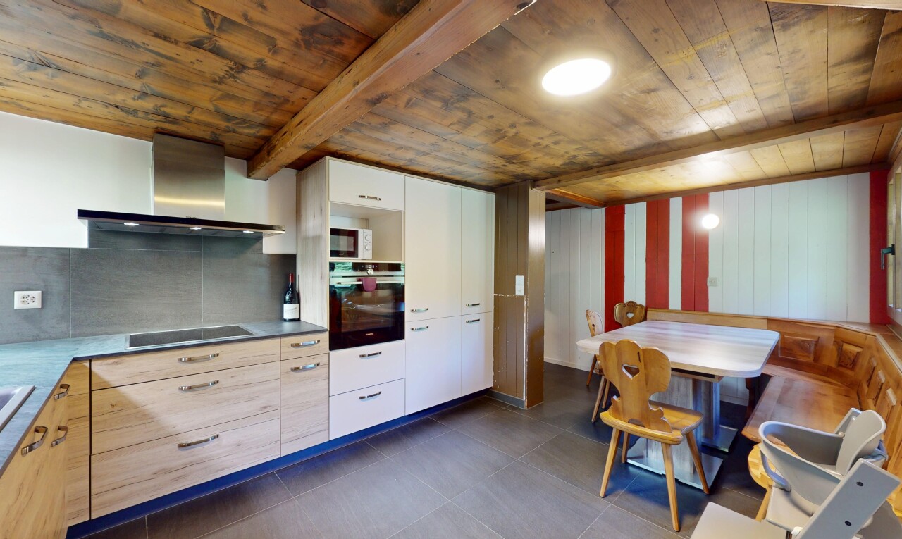 kitchen featuring oven, wall chimney exhaust hood, a wood ceiling with exposed beams, black electric stovetop, and modern cabinets