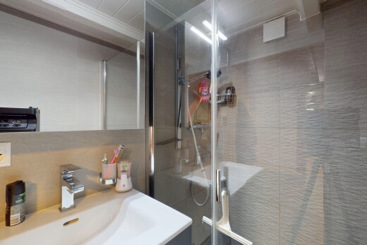 full bath featuring vanity, a stall shower, and crown molding