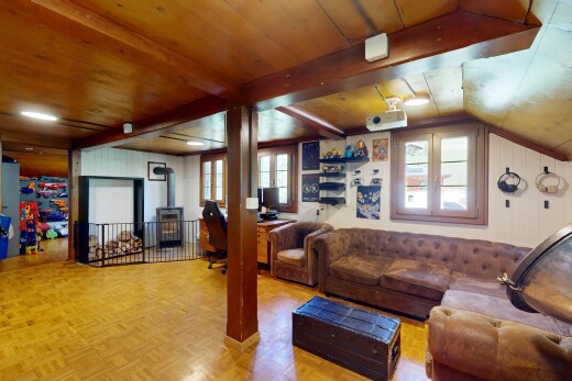 living room with a wood stove, vaulted ceiling, and wood ceiling