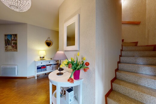 staircase featuring parquet floors and radiator heating unit