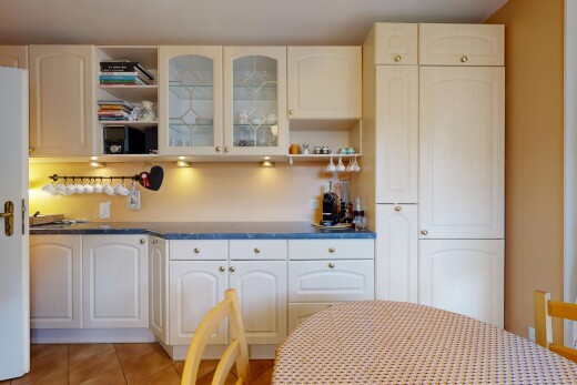 kitchen featuring glass insert cabinets, open shelves, and light tile patterned floors