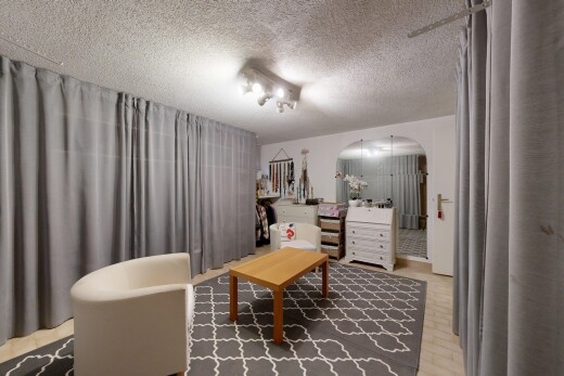 dining area featuring arched walkways and a textured ceiling