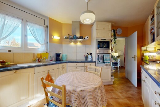 kitchen featuring dark countertops, stainless steel double oven, backsplash, and light tile patterned floors
