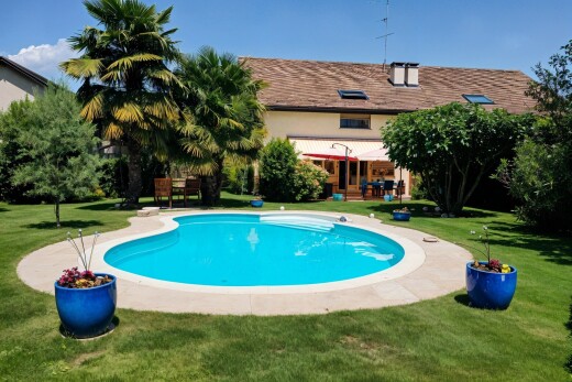 swimming pool with a lawn and a patio