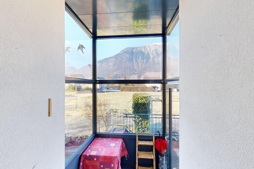 balcony with a sunroom and a mountain view