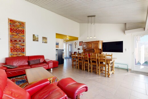 living room with a towering ceiling and light tile patterned flooring
